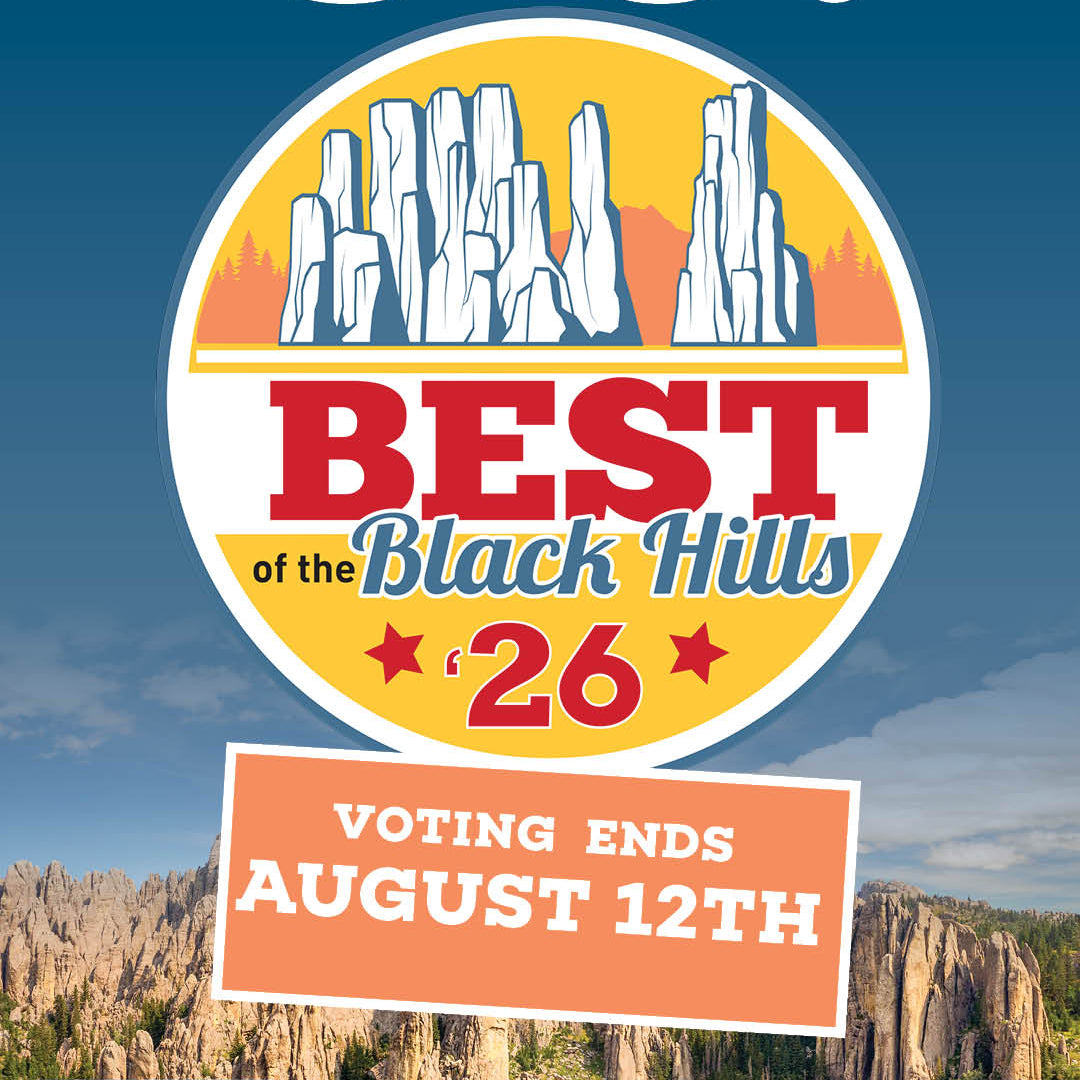 A promotional voting poster for the Black Hills 26 with large white text reading 'VOTE FOR US!' on a blue sky background, a circular mountain logo, a voting end date box, a QR code, and a small 'We're voting!' badge.